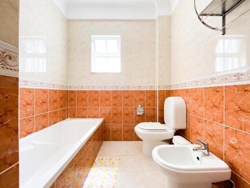 a bathroom with a tub and a toilet and a sink at Simple Beach Lovers' Retreat in Espiche #1888 in Espiche