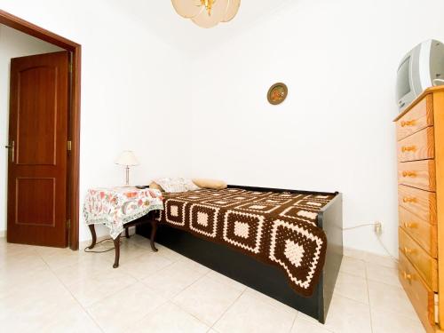 a bedroom with a bed and a table with a lamp at Simple Beach Lovers' Retreat in Espiche #1888 in Espiche