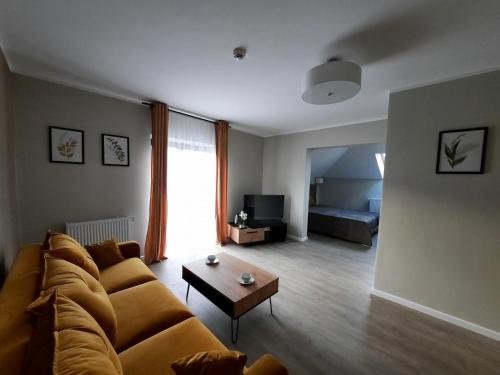 a living room with a couch and a coffee table at Rezydencja Biały Dworek in Wisła
