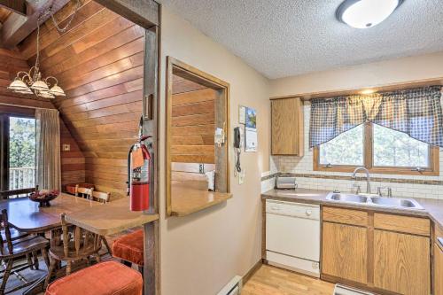 a kitchen and dining room with a table and a counter at Cozy Black Hills Nature Retreat with Private Deck! in Rapid City