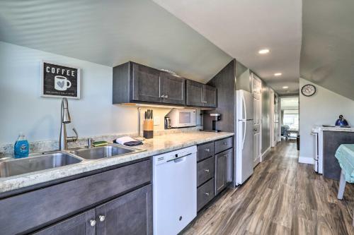 a kitchen with wooden cabinets and a sink at Old Orchard Beach Apartment - Quick Walk to Beach! in Old Orchard Beach