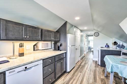 a kitchen with wooden cabinets and white appliances at Old Orchard Beach Apartment - Quick Walk to Beach! in Old Orchard Beach