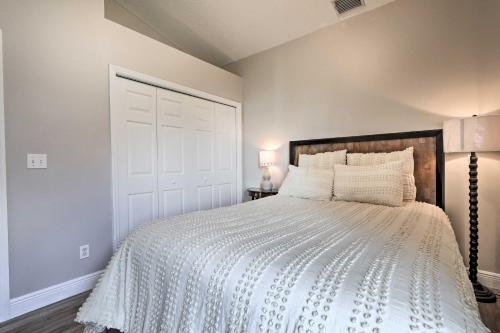 a bedroom with a bed with a white bedspread at Dog-Friendly Lake Home with Dock about 25 Mi to Disney! in Clermont