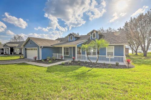 a house with a palm tree in a yard at Dog-Friendly Lake Home with Dock about 25 Mi to Disney! in Clermont