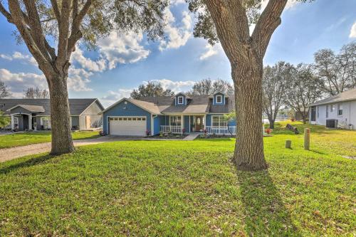 a house with three trees in a yard at Dog-Friendly Lake Home with Dock about 25 Mi to Disney! in Clermont