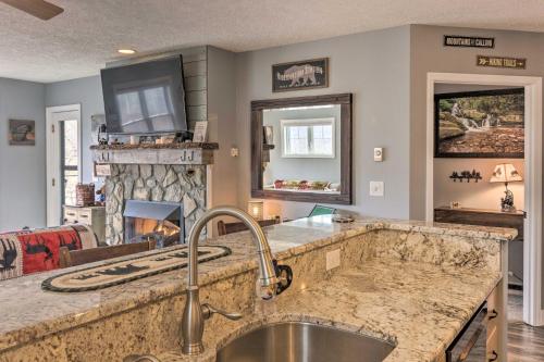 a kitchen with a sink and a fireplace at Updated Seven Devils Condo with Deck and Mountain View in Seven Devils