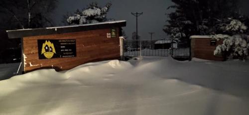 a pile of snow in front of a fence at Les Chalets Du Goulet in Le Bleymard