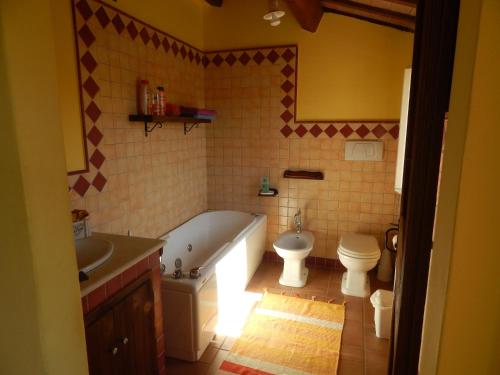 a bathroom with a tub and a toilet and a sink at la campagna al mare in Sirolo