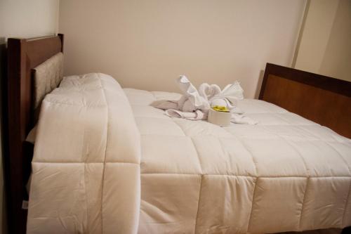 a white bed with a towel on top of it at Hotel Imperial Zumbahua & Quilotoa Lodge in Zumbahua