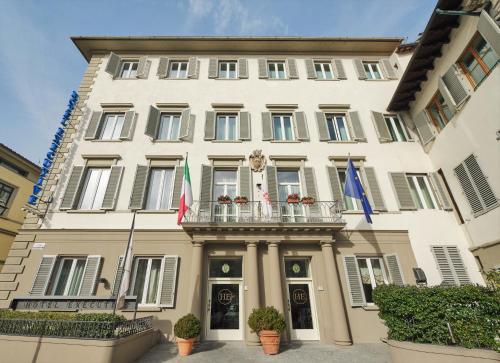 a building with flags in front of it at Hotel Executive in Florence