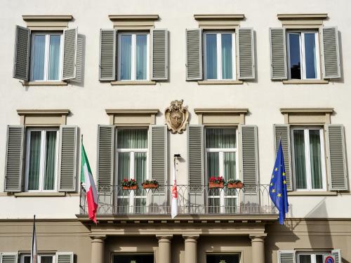 a building with flags in front of it at Hotel Executive in Florence