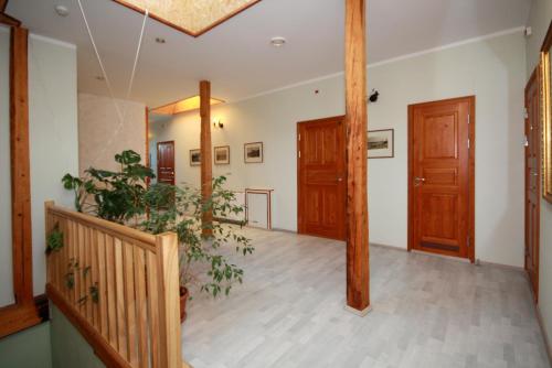 a hallway with wooden doors and potted plants at Sadama street Villa in Pärnu