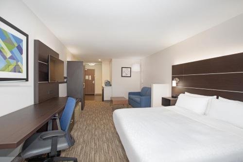 a hotel room with a bed and a desk at Holiday Inn Express Hotel & Suites Longmont by IHG in Longmont