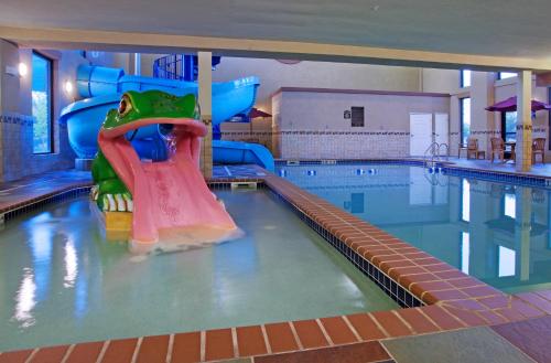 a indoor swimming pool with a water slide at Holiday Inn Express Hotel & Suites Longmont by IHG in Longmont