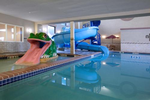 a pool with a water slide in the middle of it at Holiday Inn Express Hotel & Suites Longmont by IHG in Longmont