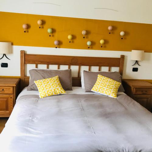 a bedroom with a large bed with yellow walls at Charming Rooms Opuntia in Carloforte
