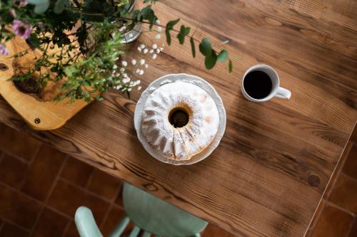a table with a doughnut and a cup of coffee at Penzion V Poli in Klimkovice