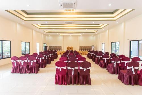 a row of chairs in a large room with purpleitures at Lumbini Palace Resort in Lumbini