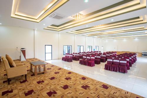 a banquet hall with purple chairs and tables in a room at Lumbini Palace Resort in Lumbini