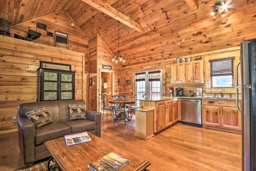 a kitchen and living room in a log cabin at 3 Mi to Dollywood Hot Tub Hideaway in Smoky Mtns in Pigeon Forge