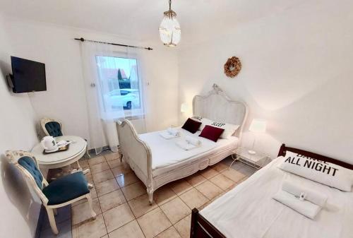 a room with a bed and a table and a couch at Pod Różą Economy in Łeba