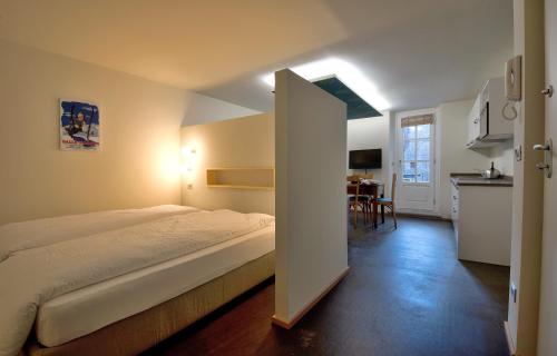 Giường trong phòng chung tại Apartements Coeur de Ville