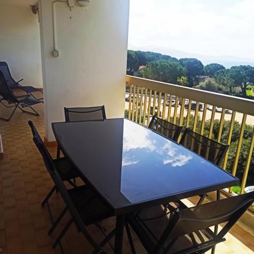 a black table and chairs on a balcony at U Riniccio in Sagone