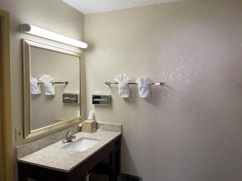 a bathroom with two sinks and a mirror at Great Western Inn & Suites in Carlsbad