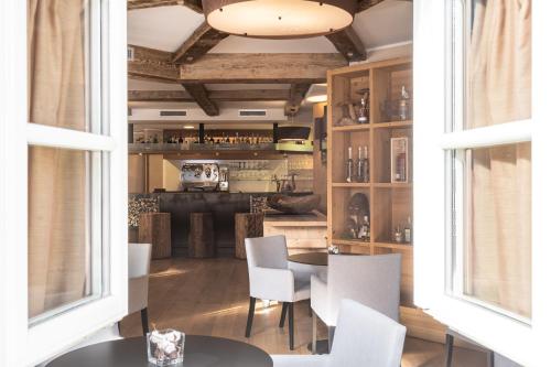 a dining room with a table and white chairs at Hotel Chalet Del Brenta in Madonna di Campiglio