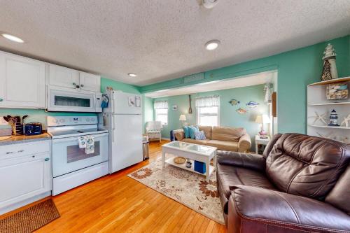 a kitchen and living room with white appliances and a couch at Hampton Beach Hangout & Nancy's Villa in Hampton