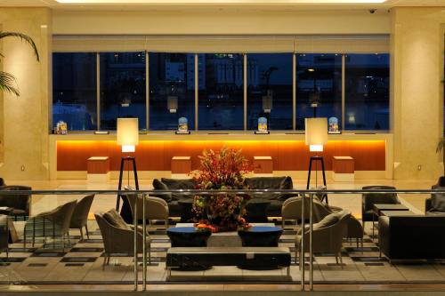 a living room filled with furniture next to a window at Hotel Keihan Universal Tower in Osaka