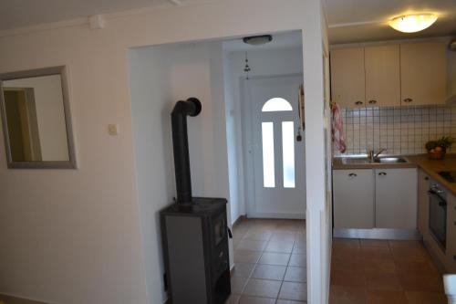 a kitchen with a stove in the middle of a room at Casablanca-Brgulje in Brgulje