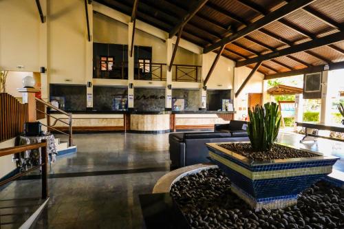 a living room with a couch and a table at Thermas Hotel Mossoró in Mossoró