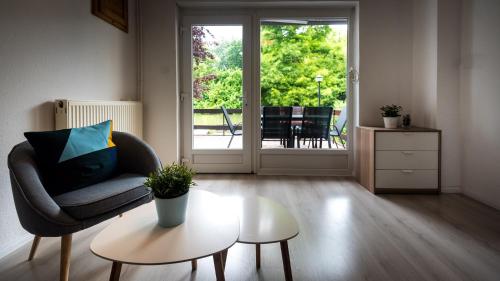 a living room with a chair and a table at Ciprus Lak in Szarvas