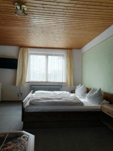 a bedroom with a large bed and a window at Gasthof zur Post in Schonstett
