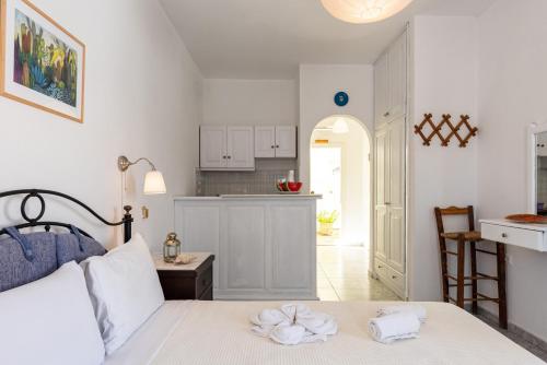 a bedroom with a bed with towels on it at Maistrali in Astypalaia Town