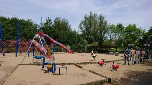 a playground with a slide in the sand at Studio Algarve in Middelkerke