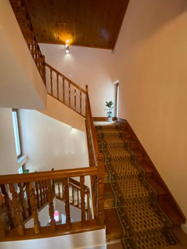 a staircase in a house with wooden railings at Guesthouse Tershana in Peshkopi