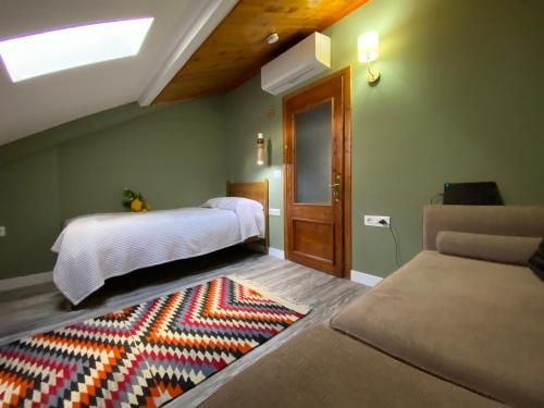 a bedroom with a bed and a rug on the floor at Guesthouse Tershana in Peshkopi