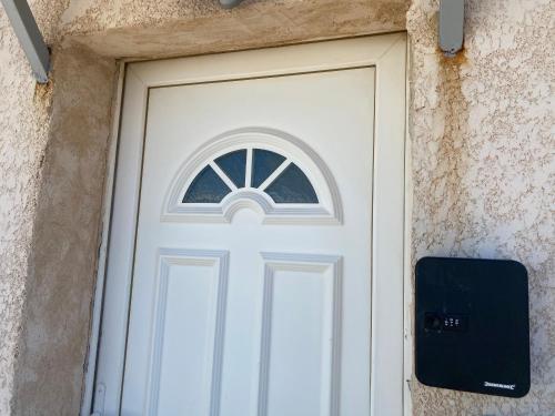 a white door in a stone building with a speaker at Studio in Brignoles