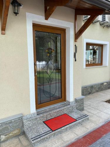 a door with a red mat in front of it at Guesthouse Tershana in Peshkopi