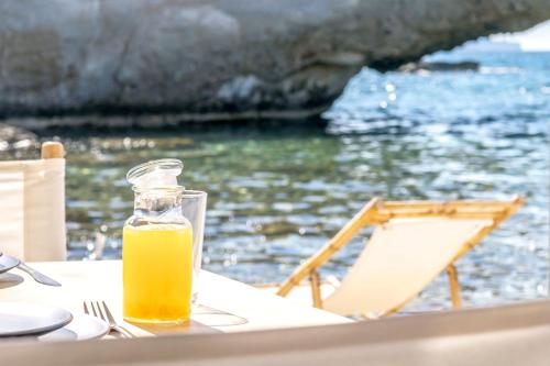 a bottle of orange juice sitting on a table next to the water at AQUA HOUSE in Pachaina
