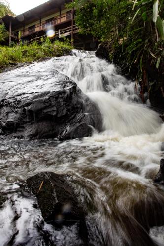 a stream of water rushing over rocks in a river at Canto das Águas Atibaia in Atibaia