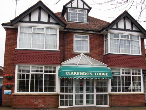 a red brick building with a sign for a claremont lodge at Clarendon Lodge - accommodation only in Skegness