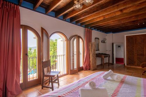 Un dormitorio con una cama grande y un balcón. en Villa Historica, en San Miguel de Balansat