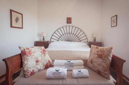 a bedroom with a bed with towels on a bench at Agriturismo Querceto in Frazione Mocaiana