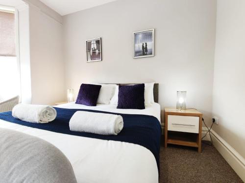 a bedroom with two beds with blue and white at Alexandra Private Studios for Work & Leisure in Swansea