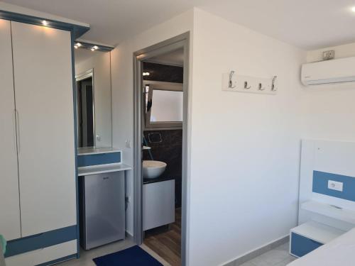 a bathroom with a toilet and a sink at Martini Vacation Home in Sarandë