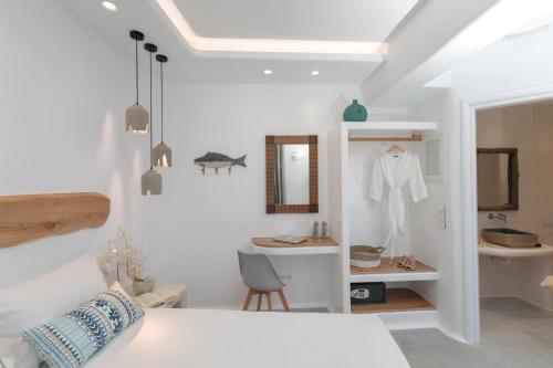 a white room with a sink and a table at HORA SUITES in Naxos Chora