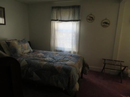 a bedroom with a bed in front of a window at Fishing Creek Lodge at Ricketts in Benton